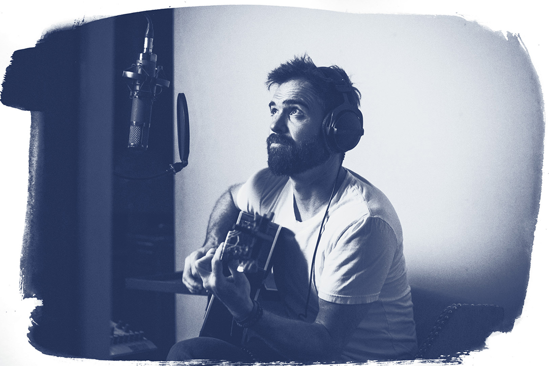 Steve Kelly recording vocals and guitar in the studio